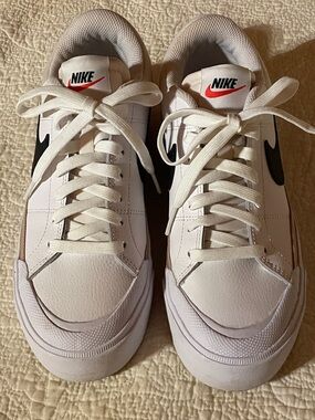 Nike White Sneakers with Black Swoosh and Red Logo